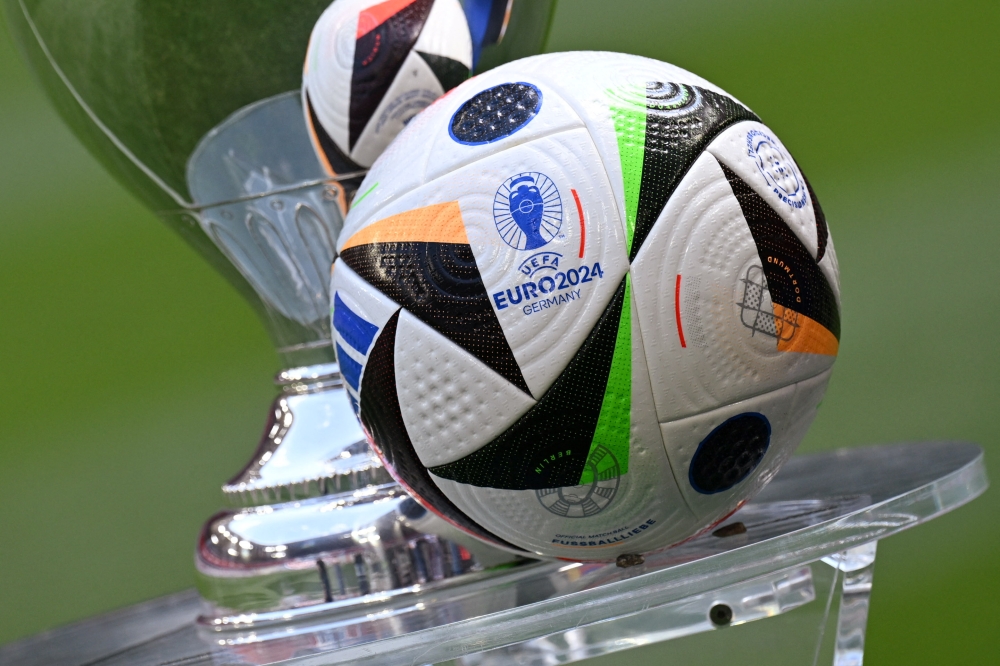 General view of the Fussballliebe match ball on display next to the European Championship trophy during the presentation at Allianz Arena, Munich, May 13, 2024. — Reuters pic 