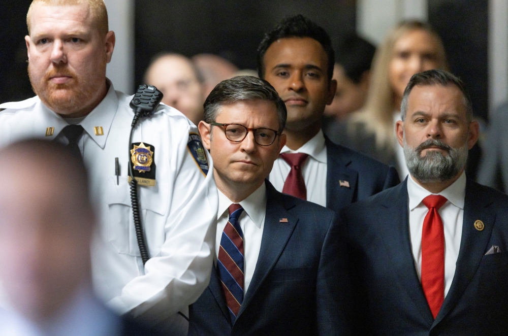 US Speaker of the House Mike Johnson, businessman Vivek Ramaswamy and Republican Congressman Cory Mills of Florida listen as former US President Donald Trump talks with reporters as he arrives for his criminal trial at New York State Supreme Court in New York, New York, May 14, 2024. — Reuters pool pic
