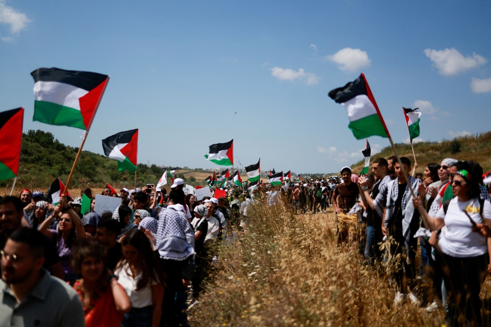 Thousands of flag-waving Palestinians marched in northern Israel yesterday to commemorate the flight and forced flight of Palestinians during the 1948 war surrounding Israel’s creation, and to demand the right of refugees to return. — Reuters pic