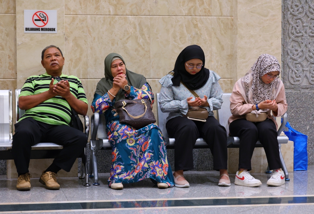 The father of the murder victim who was a former student of the National Defense University of Malaysia (UPNM) Zulfarhan Osman Zulkarnain, Zulkarnain Idros (left) and his wife Hawa Osman (second left) and family members also appeared at the Appeal Court at the Palace of Justice in Putrajaya, May 15, 2024. — Bernama pic