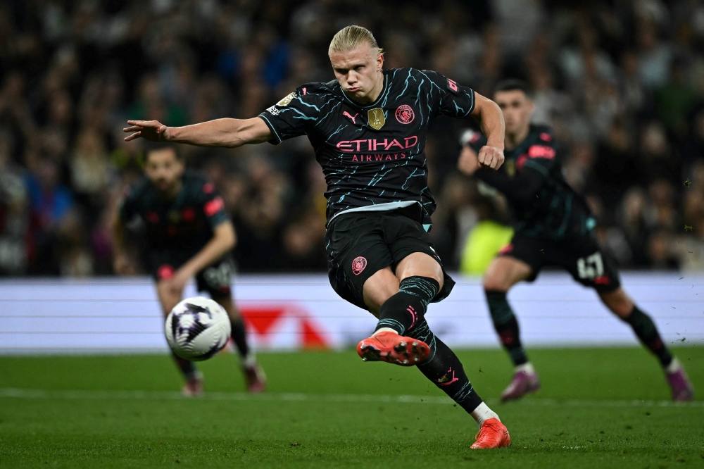 Manchester City’s Norwegian striker Erling Haaland shoots a penalty kick and scores his team second goal during the English Premier League football match between Tottenham Hotspur and Manchester City at the Tottenham Hotspur Stadium in London, on May 14, 2024. — AFP pic 
