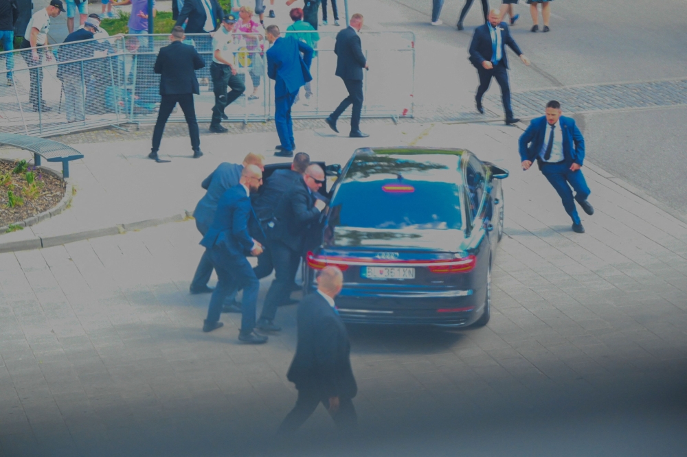 Security officers move Slovak PM Robert Fico in a car after he was injured in a shooting incident, after a Slovak government meeting in Handlova, Slovakia, May 15, 2024. — Reuters pic
