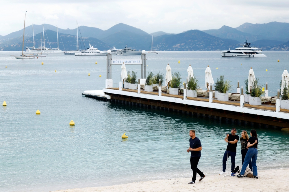 While the Cannes Film Festival conjures visions of glamorous celebrities on the red carpet and yacht parties, the main attraction is the film market, where industry players, big and small, gather to do business. — Reuters pic