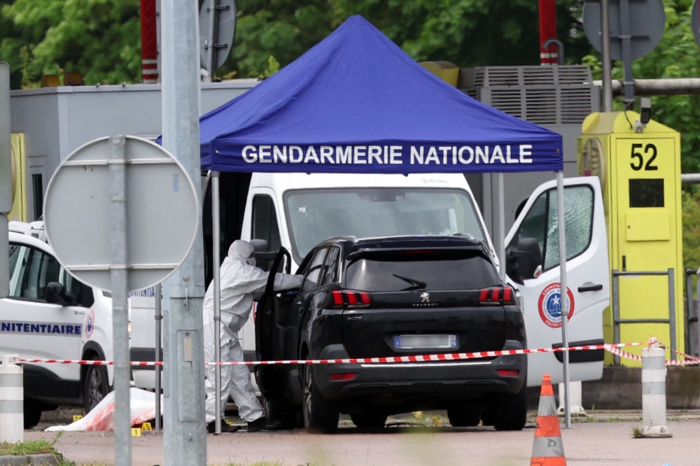 French authorities yesterday were hunting for a group of gunmen who killed two prison officers in an attack at a motorway toll that freed a convict linked to gangland drug killings, with an international alert also issued. — AFP pic