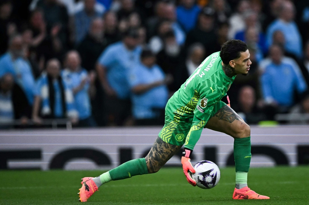 Manchester City’s Brazilian goalkeeper Ederson throws the ball during the English Premier League football match between Tottenham Hotspur and Manchester City at the Tottenham Hotspur Stadium in London, on May 14, 2024. — AFP pic 