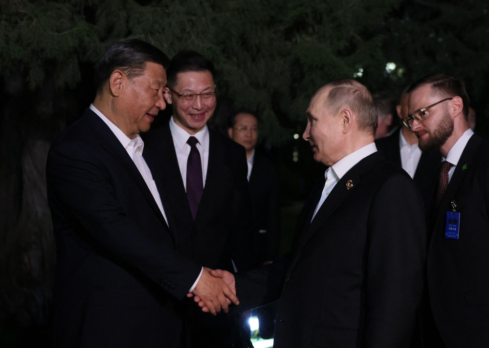 In this pool photograph distributed by the Russian state agency Sputnik, Russia's President Vladimir Putin and China's President Xi Jinping shake hands after their talks in Beijing on May 16, 2024. — Mikhail Metzel / Pool / AFP pic via Sputnik