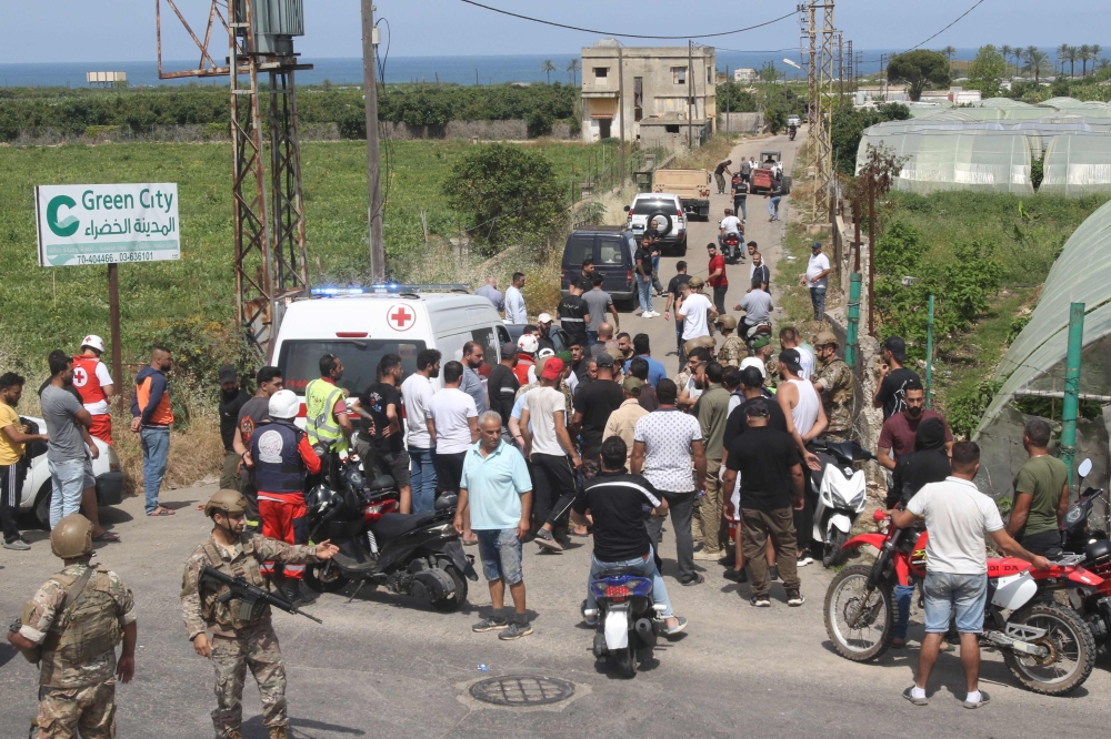 Lebanese soldiers, an ambulance and civilians gather near the site of Israeli bombardment in the village of Zahrani on May 17, 2024, in southern Lebanon near the border with Israel. — AFP pic