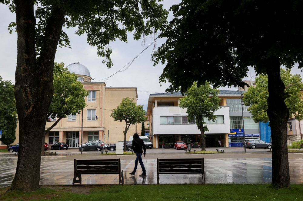A person walks at the scene after a shooting incident in which Slovak Prime Minister Robert Fico was wounded, outside the House of Culture, in Handlova, Slovakia May 17, 2024. — Reuters pic  