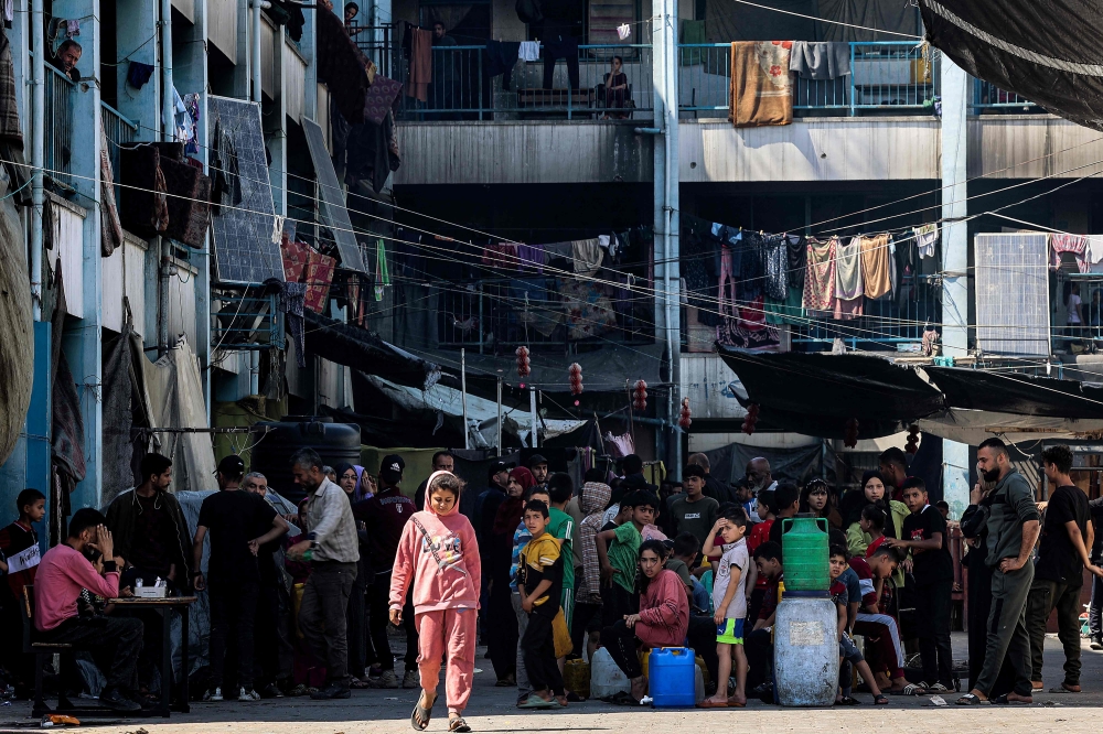 A girl walks in the yard of a school of the United Nations Relief and Works Agency for Palestine Refugees in the Near East (UNRWA), housing Palestinians displaced by the ongoing conflict in the Gaza Strip between Israel and Hamas, in Jabalia in the north of the Palestinian territory on May 14, 2024. — AFP pic