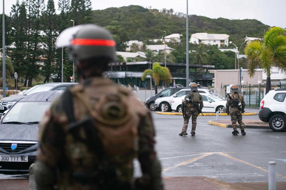 Hundreds of heavily armed French soldiers and police patrolled the debris-filled streets of Noumea Saturday. — AFP pic