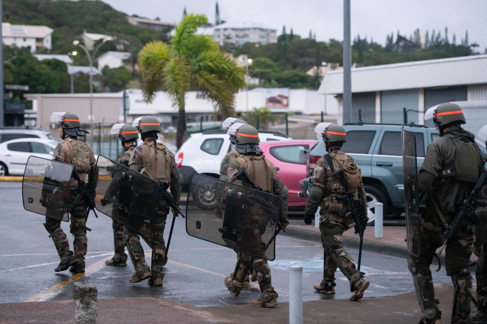 French soldiers of the 8th Marine Infantry Regiment secure the Magenta airport in Noumea. — AFP pic