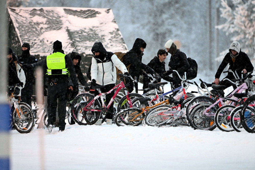Migrants arrive with bicycles to the international border crossing at Salla, northern Finland, November 23, 2023. — Lehtikuva pic via Reuters
