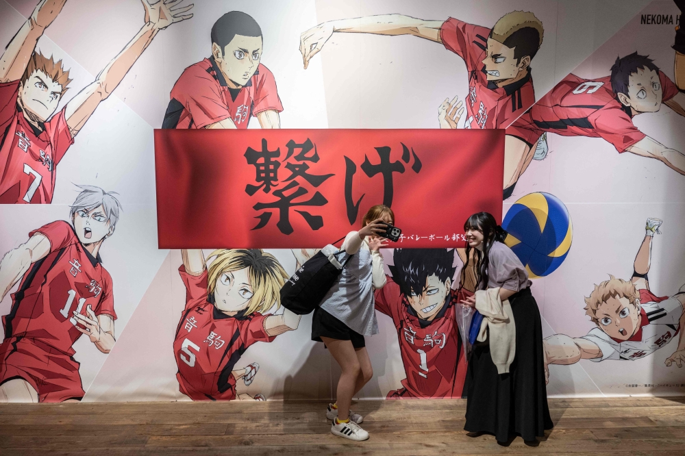 This picture taken on April 19, 2024 shows people taking selfies at a pop-up store for the Japanese volleyball manga series 'Haikyu!!' in Tokyo. — AFP pic