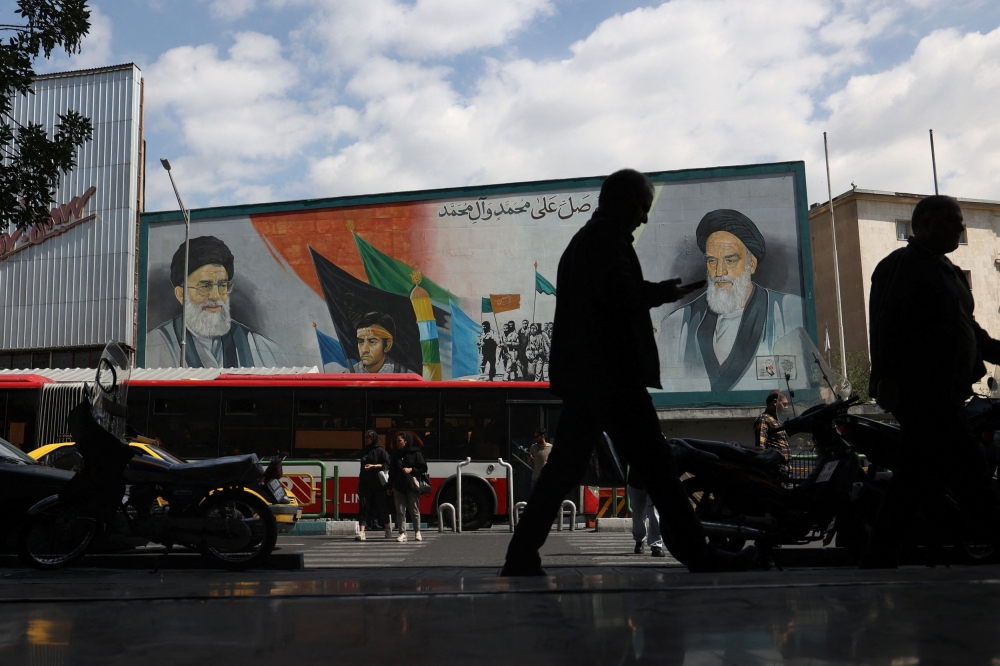A mural depicting the late leader of the Islamic Revolution Ayatollah Ruhollah Khomeini and Iran's Supreme Leader Ayatollah Ali Khamenei are seen on a building in a street in Tehran, Iran May 20, 2024. — Wana pic via Reuters