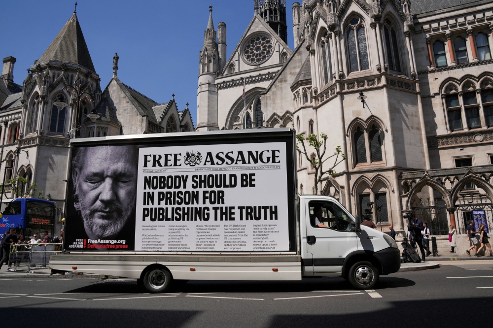 A car with a message in support of WikiLeaks founder Julian Assange drives in front of the High Court, on the day of an extradition hearing of Julian Assange, in London, Britain, May 20, 2024. — Reuters pic
