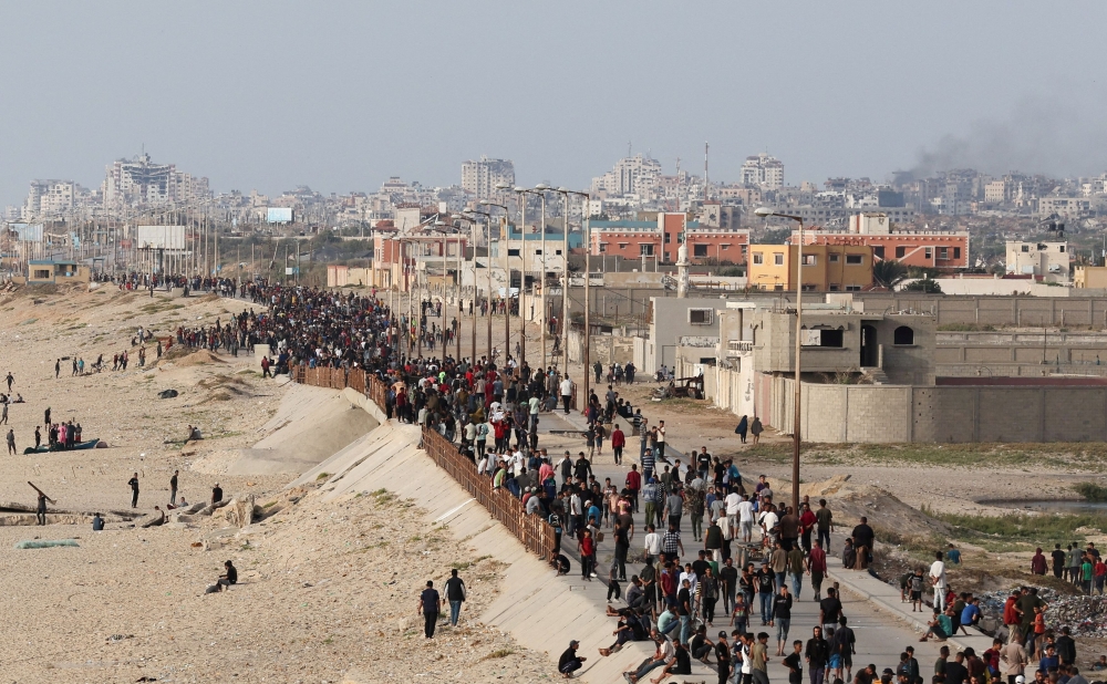 Palestinians gather in the hope of obtaining aid delivered into Gaza through a US-built pier, amid the ongoing conflict between Israel Hamas, as seen from central Gaza Strip May 19, 2024. — Reuters pic