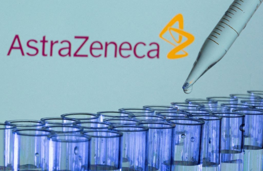 Test tubes are seen in front of a displayed AstraZeneca logo in this illustration taken, May 21, 2021. — Reuters pic
