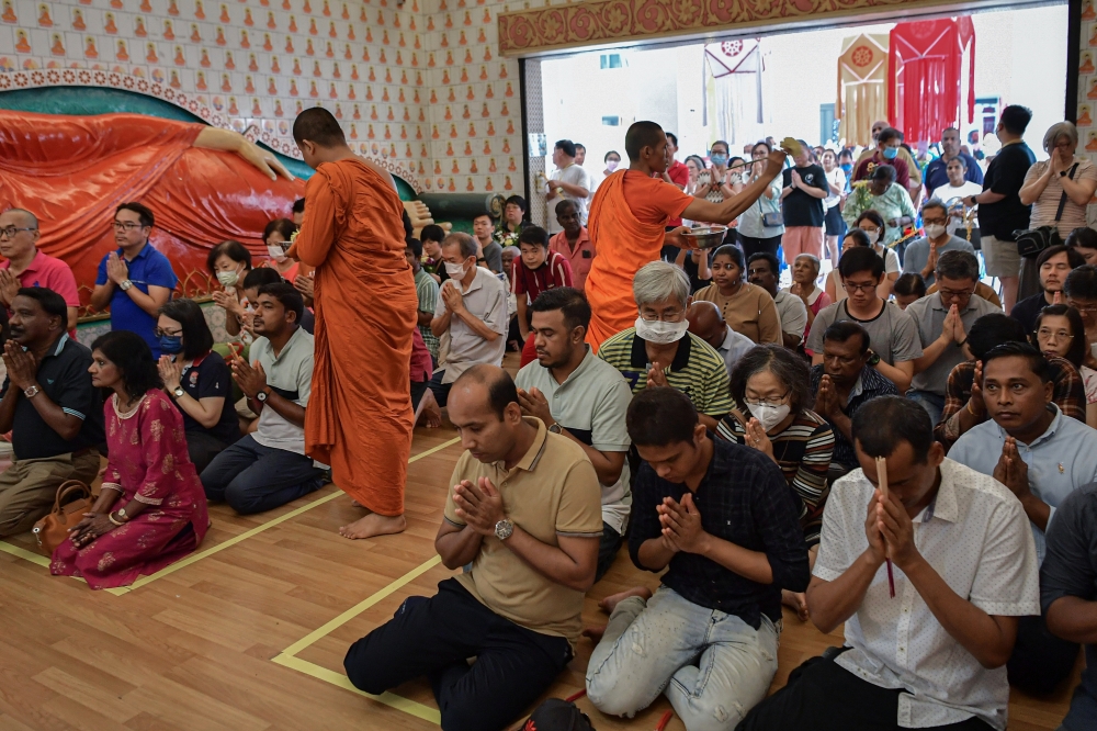 Buddhist monks sprinkle ‘holy water’ on Buddhists performing religious ceremonies in conjunction with Wesak Day at Maha Vihara Buddhist Temple, Brickfields, May 22, 2024. — Bernama pic 