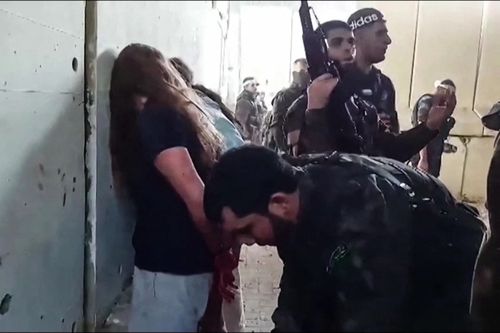 This video grab from footage released by the Israeli Hostage and Missing Families Forum campaign group on May 22, 2024, shows what the group described as Israeli female soldiers being captured by Hamas during the October 7, 2023 attack on Israel. — AFP pic/Hostages and Missing Families Forum campaign group 