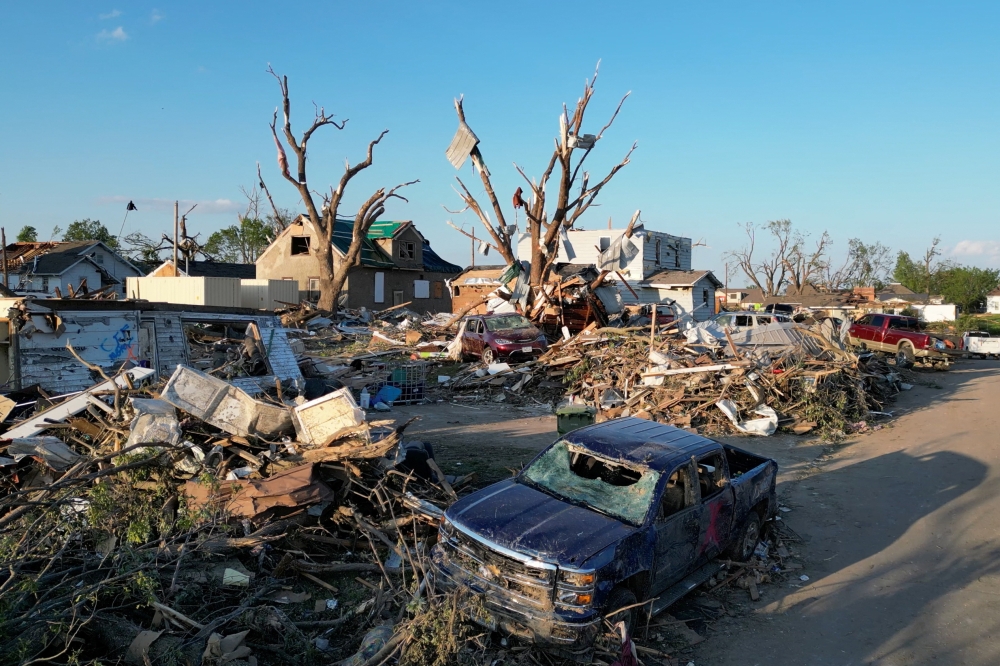 Rescue teams in Iowa searched through the ruins of homes and buildings in Greenfield yesterday, looking for survivors of a deadly tornado that tore through the town the day before. — Reuters pic