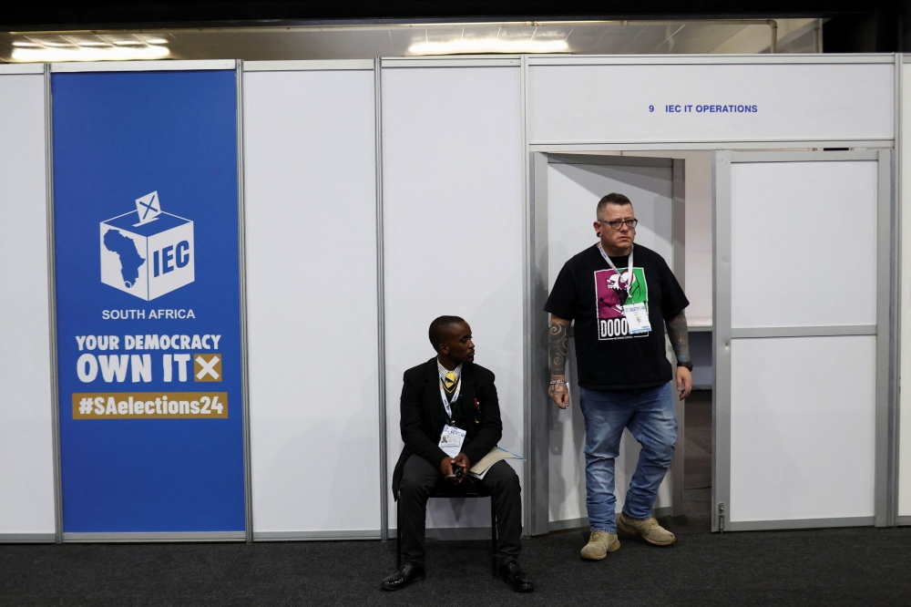 A security guard works the entrance to the IT operations booth, while a worker exists, during the opening ceremony of the National Results Operation Centre of the Electoral Commission of South Africa (IEC) in Midrand, Johannesburg, South Africa, May 22, 2024. — Reuters pic