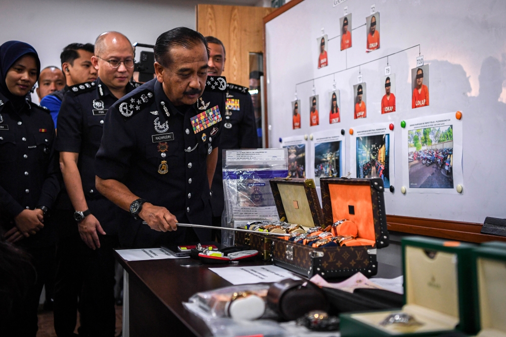 Inspector-General of Police Tan Sri Razarudin Husain with the confiscated items during a press conference in Kuala Lumpur, May 24, 2024. — Bernama pic 