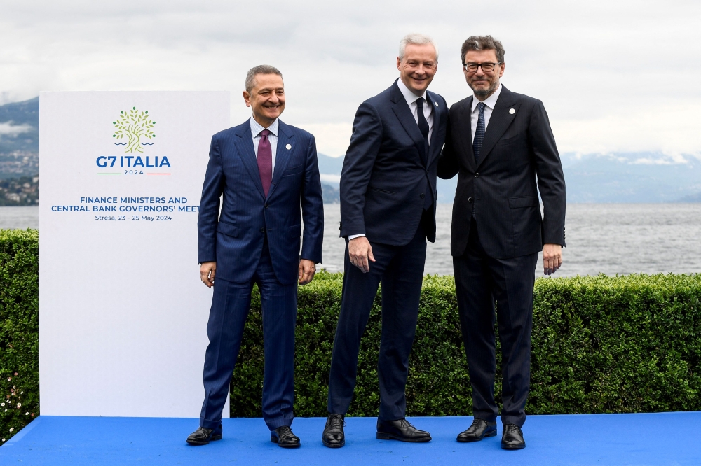 Bank of Italy Governor Fabio Panetta, France's Minister for Economy and Finances Bruno Le Maire and Italy's Minister of Economy and Finance Giancarlo Giorgetti pose for a picture at the G7 Finance Ministers and Central Bank Governors' Meeting in Stresa, Italy May 24, 2024. — Reuters pic  