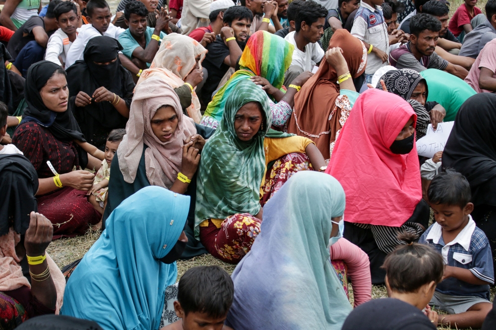 Rohingya people wait to be processed at a temporary processing centre in Lhokseumawe, Aceh province on November 23, 2023. — AFP pic