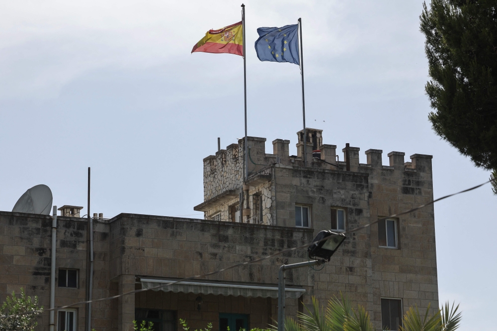 The Spanish and European Union flags flutter on the consulate of Spain building in the Sheikh Jarrah neighbourhood of Israeli-annexed east Jerusalem May 22, 2024. — AFP pic