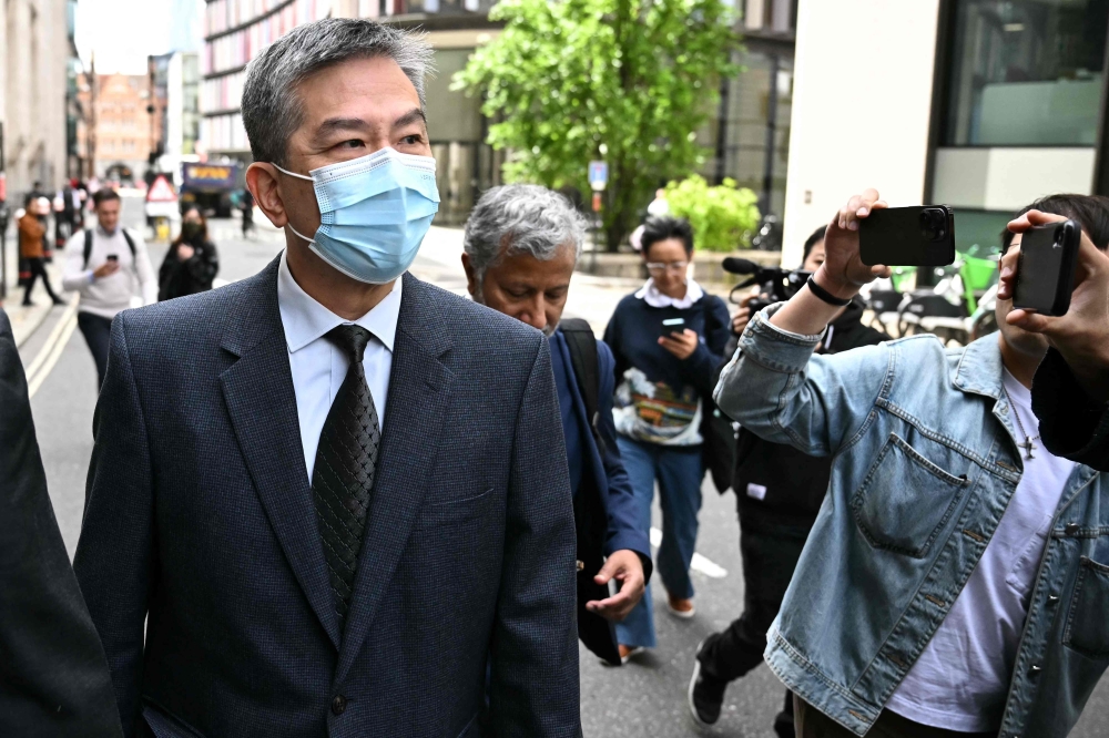 Chung Biu Yuen leaves after a hearing at the Old Baily in central London on May 24, 2024 over allegations of assisting Hong Kong's intelligence services in a Chinese-linked espionage case. — AFP pic