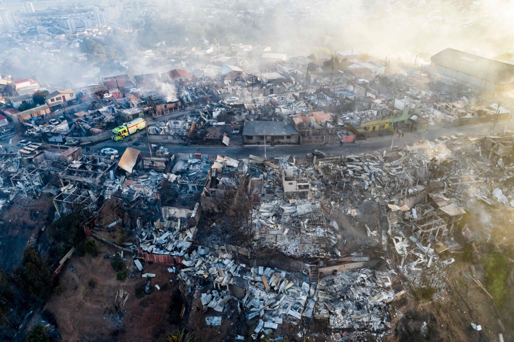 Aerial view of houses destroyed by a forest fire that affected the hills of Vina del Mar, in the Valparaiso region, Chile, taken December 23, 2022. A Chilean firefighter was arrested on May 24, 2024, accused of starting a blaze that killed 137 people in Vina del Mar, police said. — AFP pic