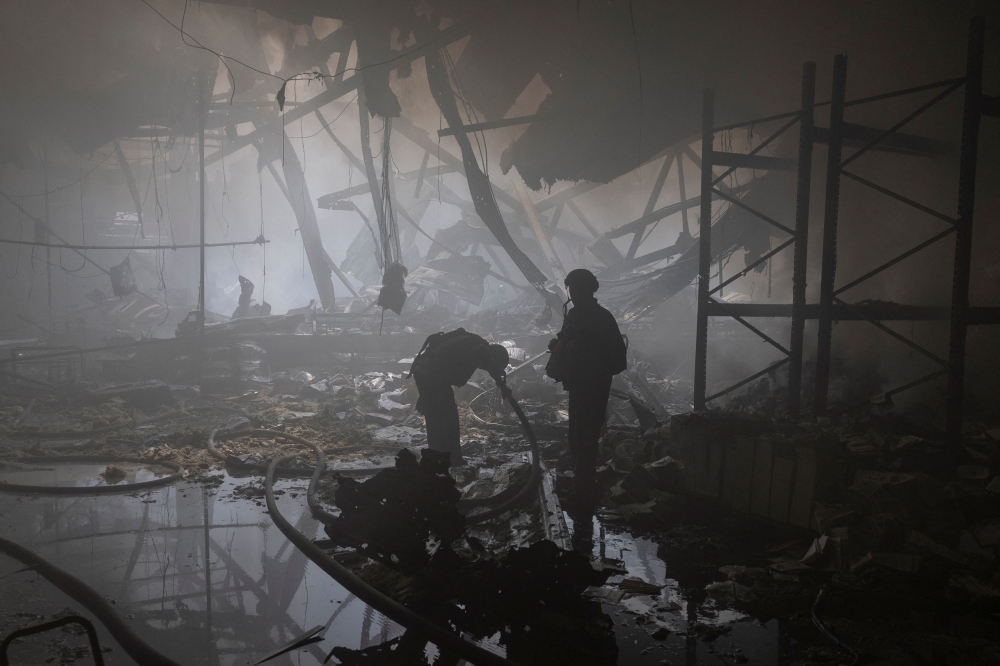 File photo of a firefighter washing up his face as he works at a compound of a printworks hit by Russian missile strikes, amid Russia’s attack on Ukraine, in Kharkiv, Ukraine May 23, 2024. — Reuters pic