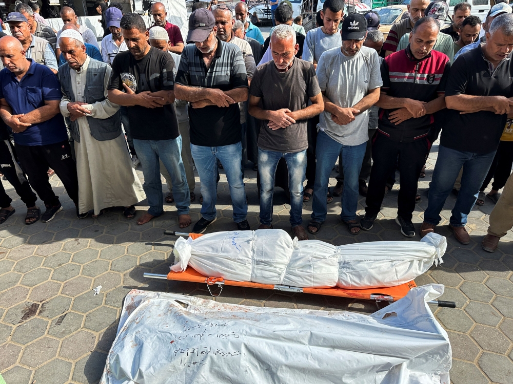 File photo of mourners praying next to the bodies of Palestinians killed in an Israeli strike, amid the ongoing conflict between Israel and the Palestinian Islamist group Hamas, in Deir Al-Balah in central Gaza Strip May 24, 2024. — Reuters pic