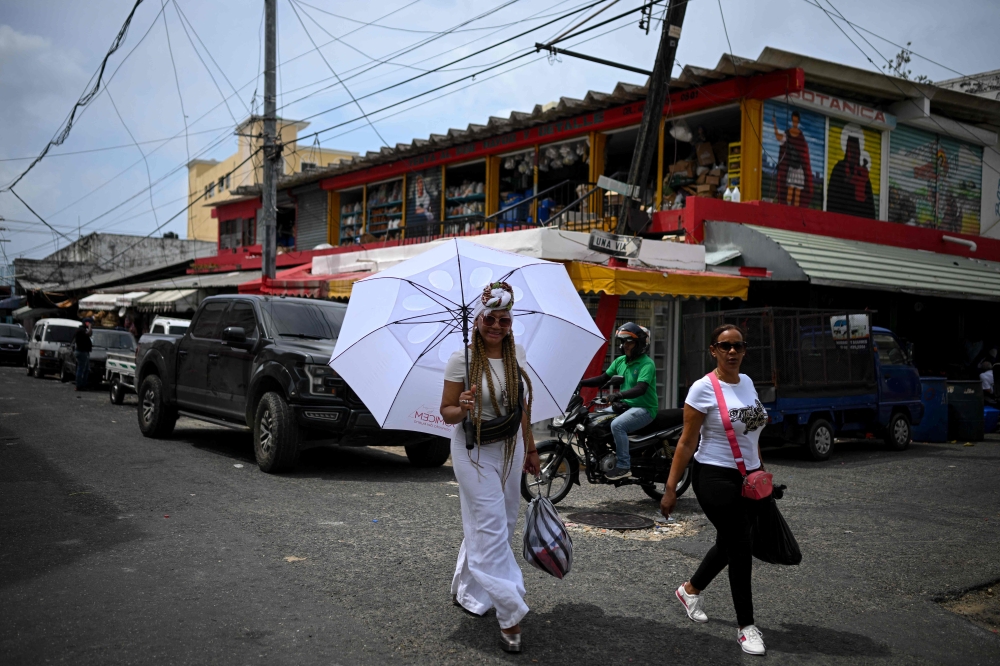 File photo of women walking down a street in a neighborhood known as ‘Little Haiti’ in Santo Domingo on May 20, 2024. — AFP pic