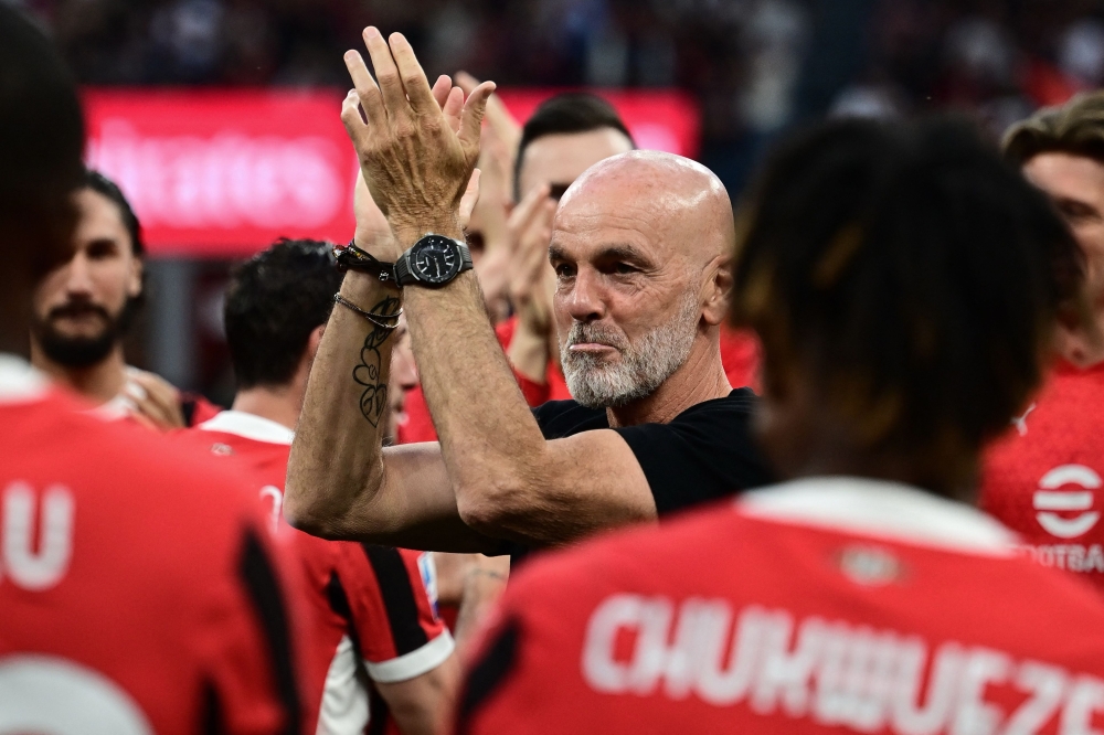 AC Milan's Italian coach Stefano Pioli is celebrated by his team as the last match by coach ahead of the Italian Serie A football match between AC Milan and Salernitana at San Siro Stadium, in Milan on May 25, 2024. as the last match by coach. — AFP pic
