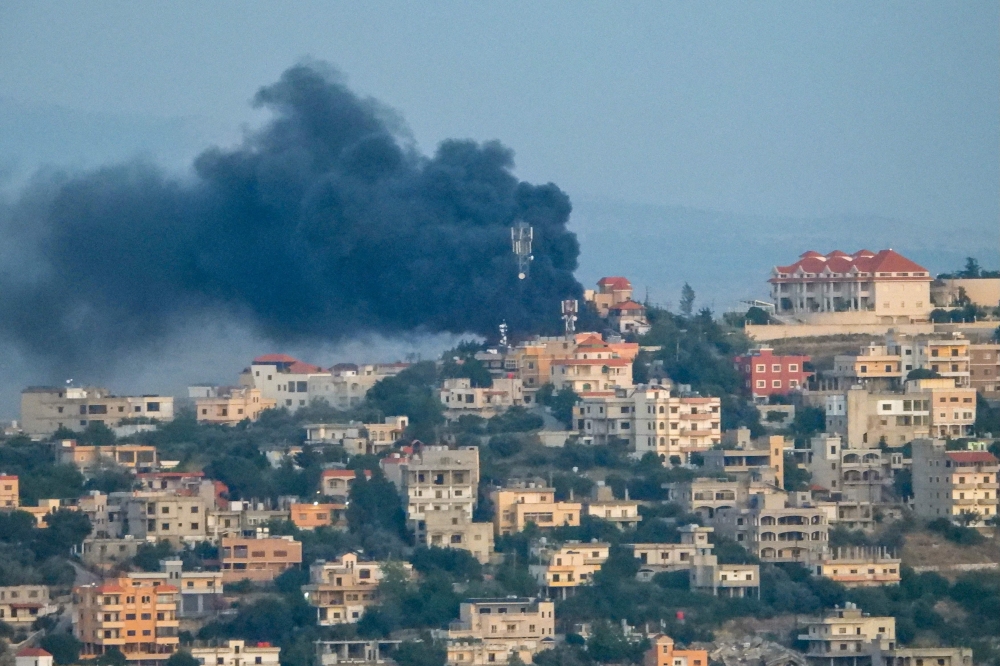 Smoke billows over the southern Lebanese village of Khiam near the border with Israel, following an Israeli airstrike. — AFP pic