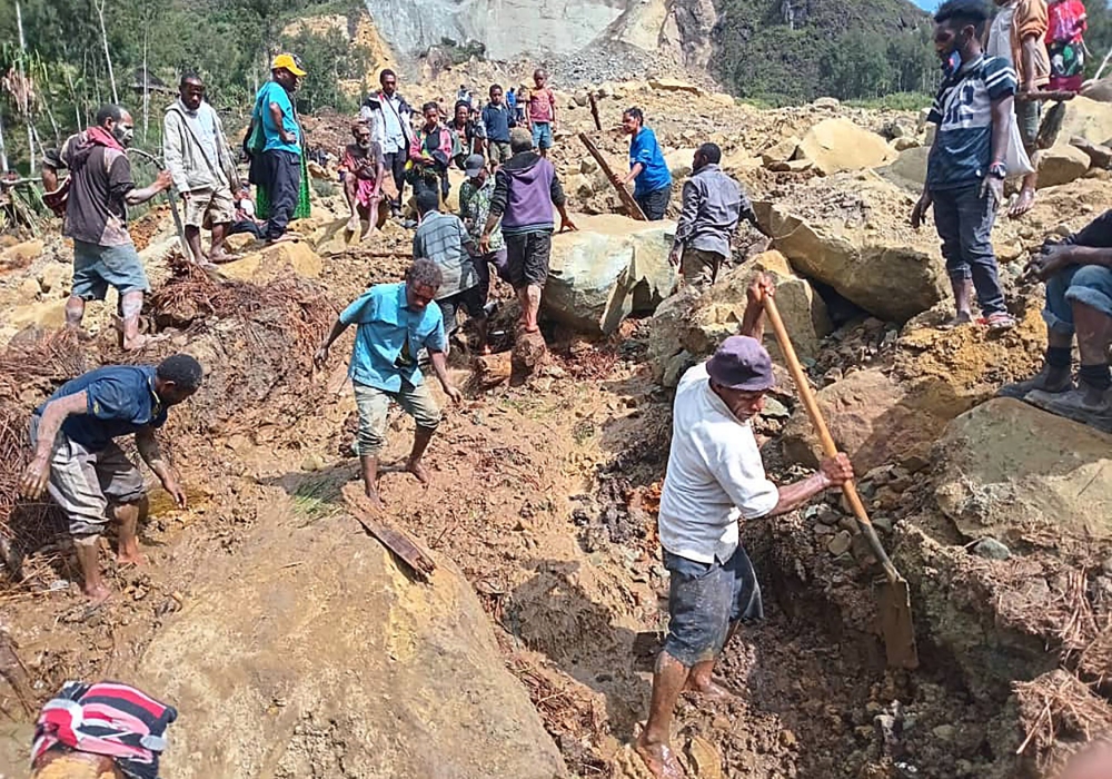 This handout photo taken and received on May 26, 2024 from the International Organization for Migration shows people digging at the site of a landslide at Yambali Village in the region of Maip Mulitaka, in Papua New Guinea. — AFP pic/International Organization for Migration/Mohamud Omer