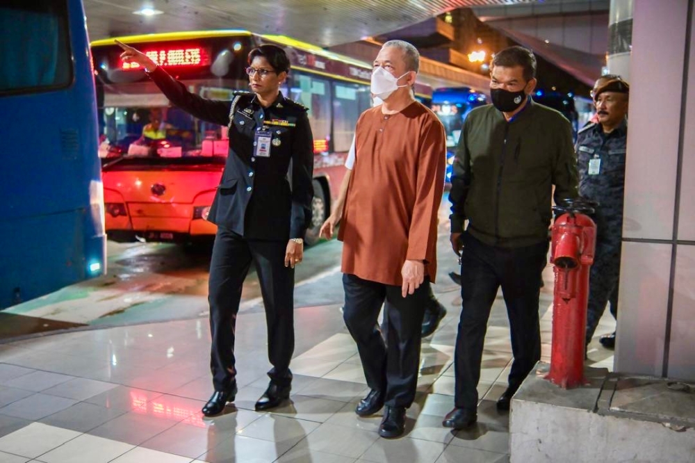 Deputy Prime Minister Datuk Seri Fadillah Yusof (in brown shirt) is accompanied by Home Minister Datuk Seri Saifuddin Nasution Ismail during a surprise visit to the Customs, Immigration and Quarantine complex in the Sultan Iskandar Building, Johor Baru May 27, 2024. — Picture courtesy of the Home Ministry 