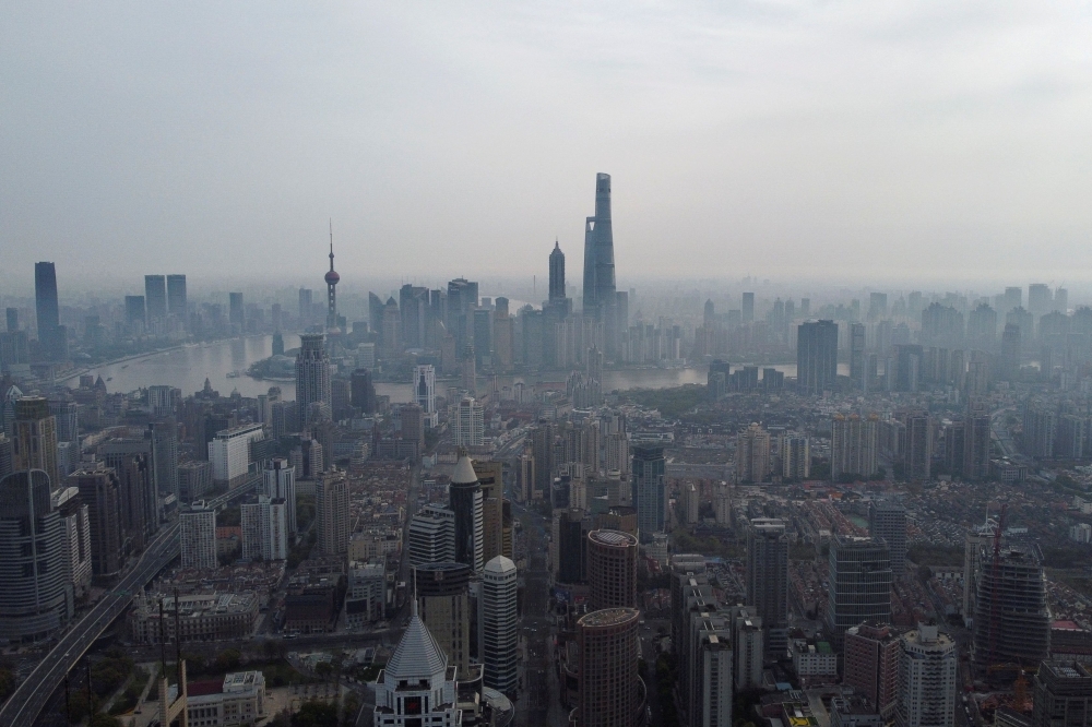An aerial view shows the Lujiazui financial district and other buildings along the Huangpu river in Shanghai, March 30, 2022. Shanghai has lowered the minimum downpayment ratios for home buyers and relaxed some home purchase restrictions, after the country lowered the national level in a market stabilising effort earlier this month. — Reuters pic  