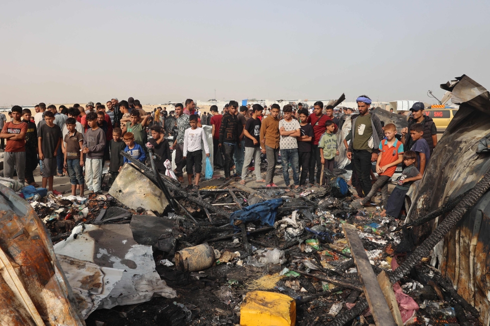 Palestinians gather at the site of an Israeli strike on a camp for internally displaced people in Rafah on May 27, 2024, amid ongoing battles between Israel and the Palestinian Hamas group. — AFP pic