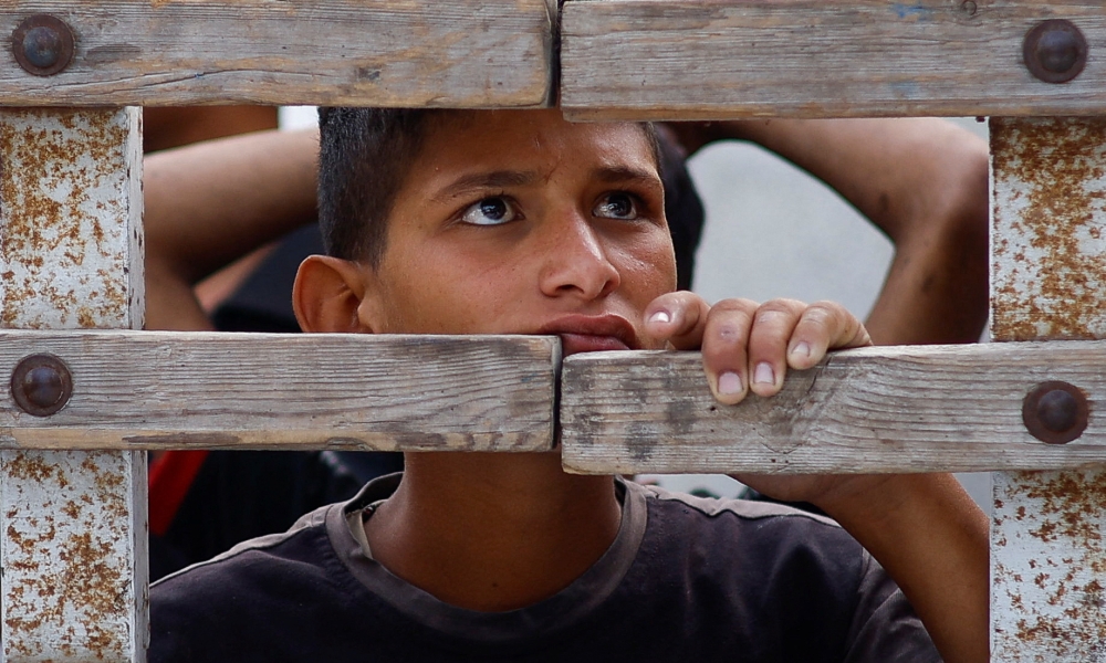 A boy looks into a vehicle carrying the bodies of Palestinians killed in an Israeli strike on an area designated for displaced people, during a funeral, in Rafah in the southern Gaza Strip May 27, 2024. — Reuters pic