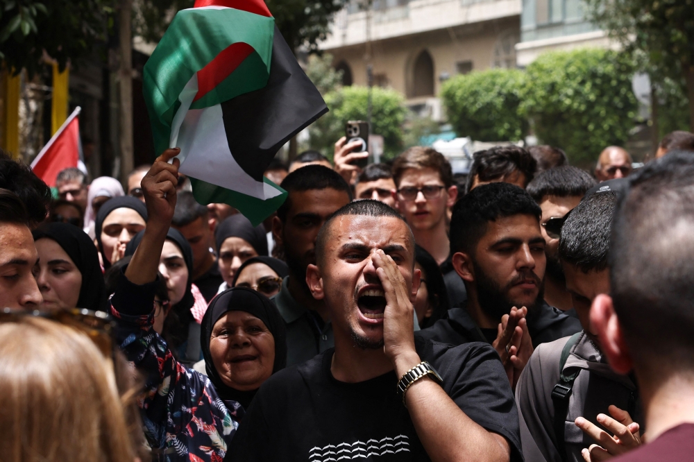 People chant slogans during a rally in Ramallah in the occupied West Bank May 27, 2024, to protest an overnight Israeli strike on a camp for internally displaced Palestinians in Rafah in the Gaza Strip. — AFP pic