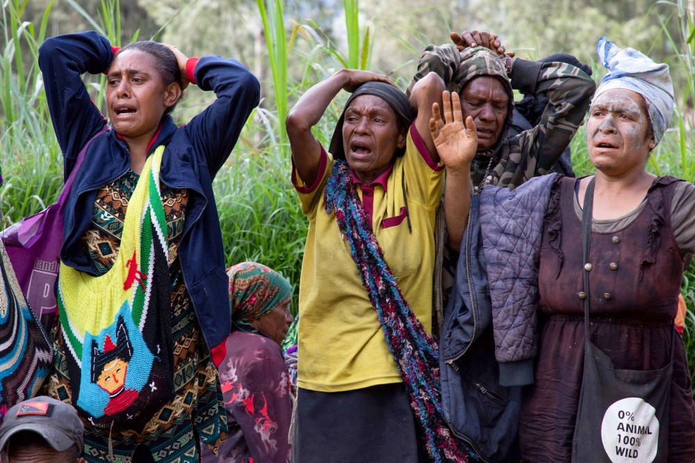 This undated handout photo taken by the UN Development Programme and released on May 28, 2024 shows locals reacting during search and rescue efforts at the site of a landslide at Mulitaka village in the region of Maip Mulitaka, in Papua New Guinea's Enga Province. — Handout by UN Development Programme via AFP