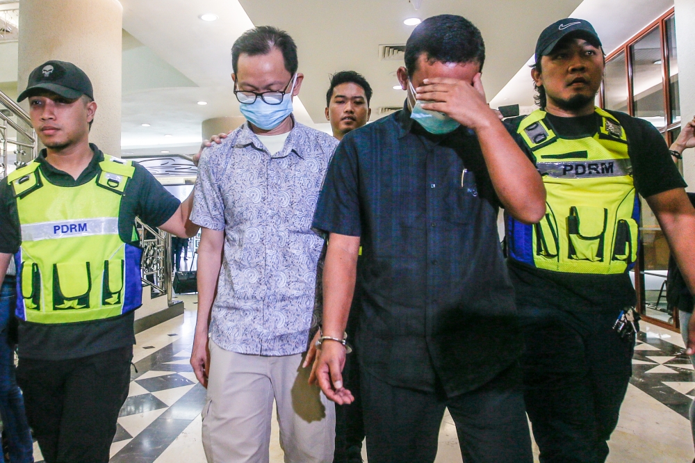 Senior Assistant Director of Forensic Accounting Investigations, Commercial Crime Investigation Department (JSJK) Bukit Aman, ACP Chin Kiam Kong, 54, and its Cryptocurrency Crime Investigation Unit head, DSP Suhairon Abdullah, 42, pleaded not guilty to two charges before Judge Azura Alwi. ― Picture by Hari Anggara