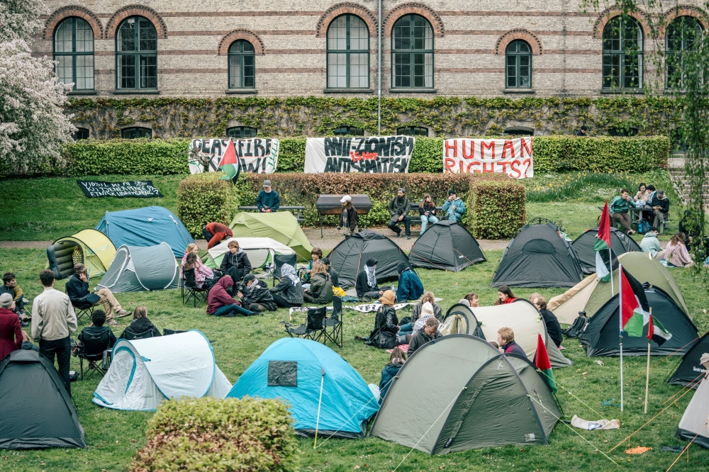 Students gather near banners at an encampment at the University of Copenhagen's City Campus, at the old Municipal Hospital amid the ongoing conflict between Israel and the Palestinian Islamist group Hamas, in Copenhagen, Denmark, May 6, 2024. —Ritzau Scanpix via Reuters 