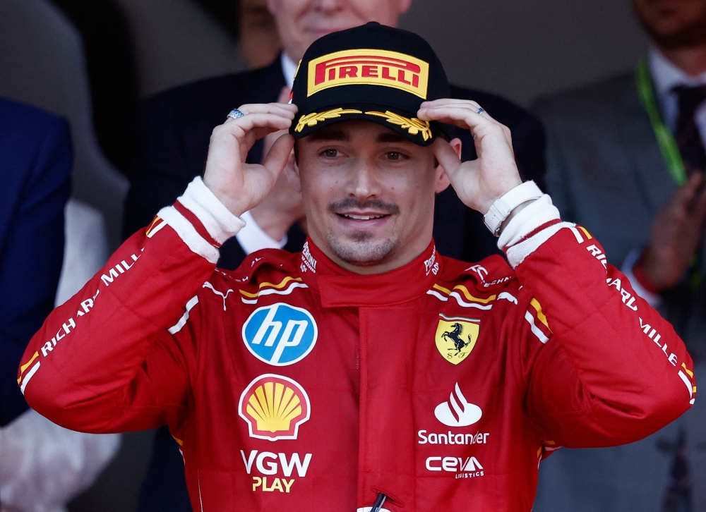 Ferrari’s Charles Leclerc celebrates on the podium after winning the Monaco Grand Prix at the Circuit de Monaco, May 26, 2024.— Reuters pic 