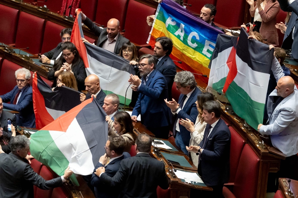 Several MPs from Italy’s opposition Five Star Movement brandished Palestinian flags in parliament yesterday during a discussion on the Middle East crisis. — AFP pic
