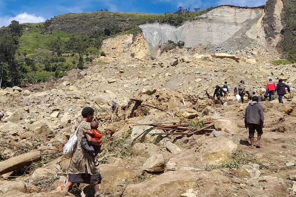 This handout photo taken on May 28, 2024 and released on May 29, 2024 by World Vision shows locals digging at the site of a landslide. — AFP pic/World Vision 