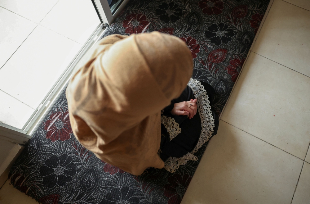Zeina, a Syrian refugee who asked her name be changed, sits inside an apartment in the Bekaa valley, Lebanon May 23, 2024. — Reuters pic