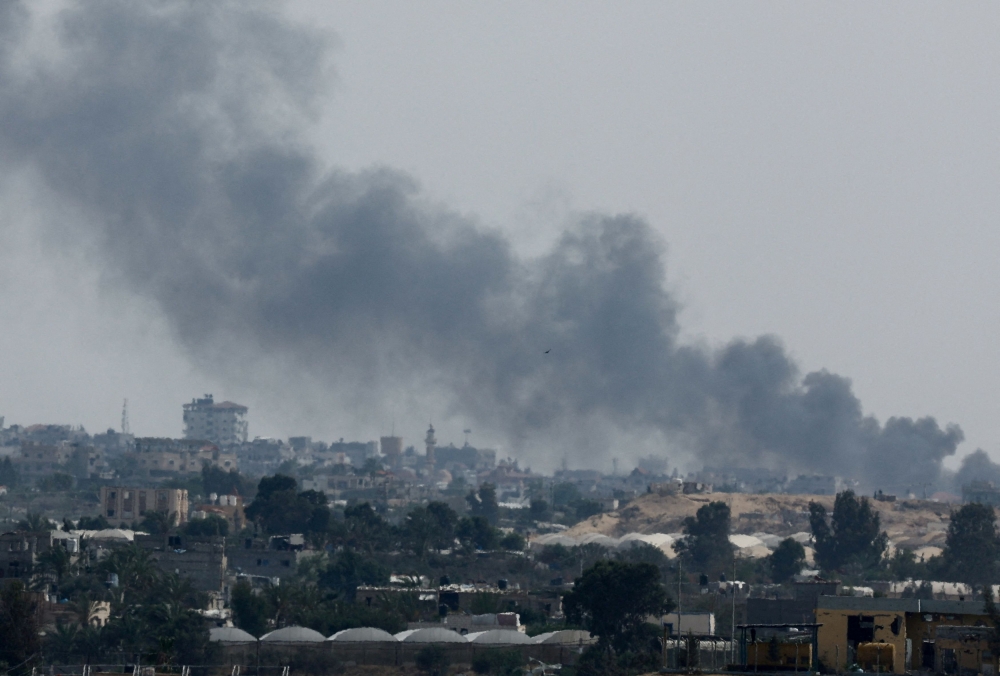 Smoke rises following Israeli strikes during an Israeli military operation in Rafah, as seen from Khan Younis, in the southern Gaza Strip, May 28, 2024. — Reuters pic